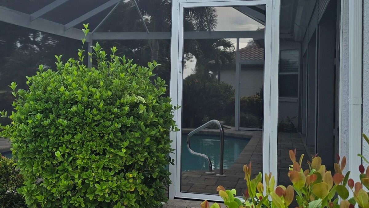 A screen door in a cage wall